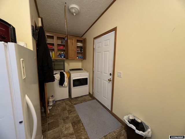 clothes washing area with separate washer and dryer, a textured ceiling, laundry area, and crown molding