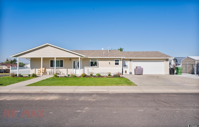 single story home with a garage, covered porch, and a front yard