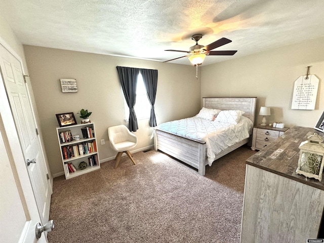 carpeted bedroom with ceiling fan and a textured ceiling