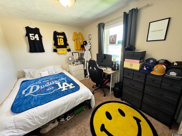 bedroom featuring a textured ceiling and carpet floors