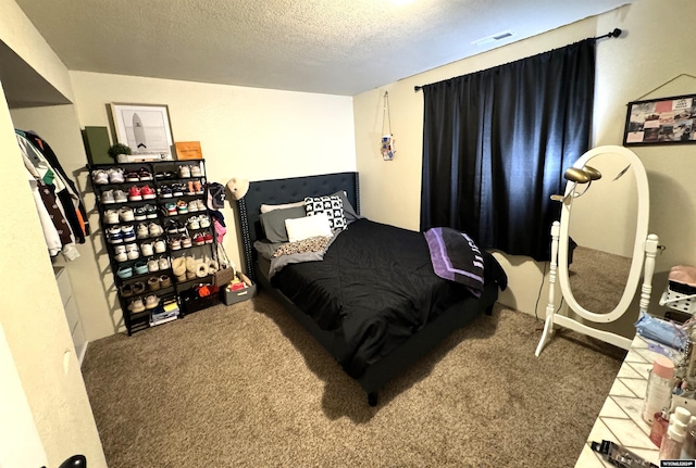 carpeted bedroom featuring a textured ceiling