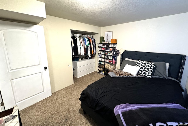 carpeted bedroom featuring a textured ceiling and a closet