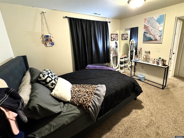 bedroom with carpet flooring and a textured ceiling