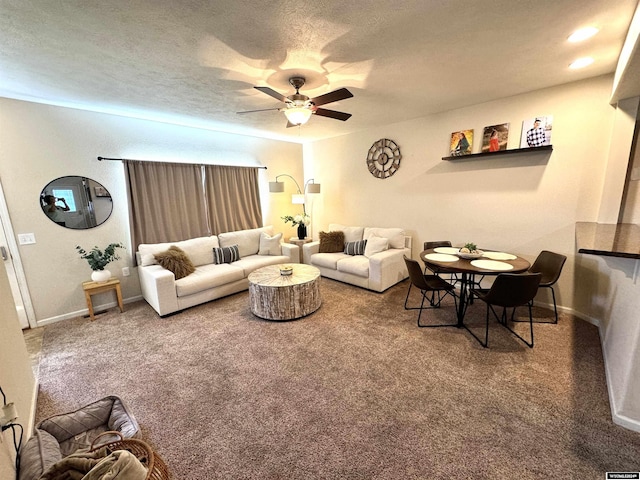 living room with carpet flooring, ceiling fan, and a textured ceiling