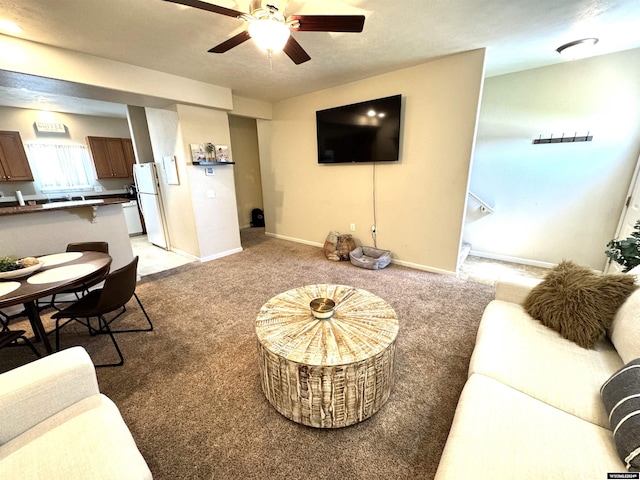 living room with ceiling fan and carpet floors