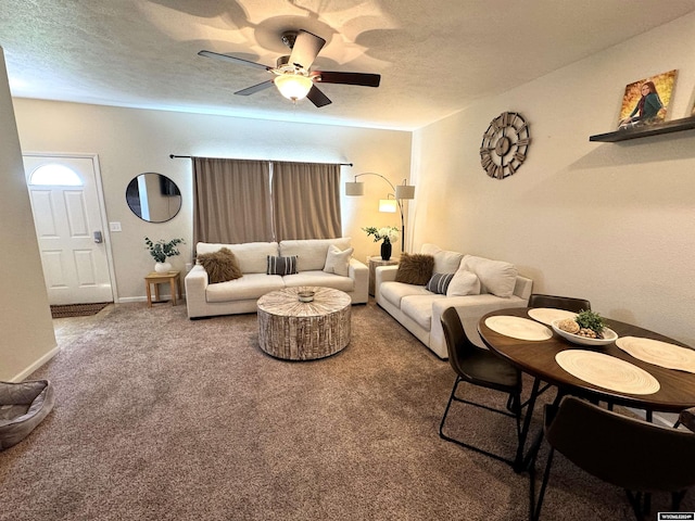 carpeted living room featuring a textured ceiling and ceiling fan