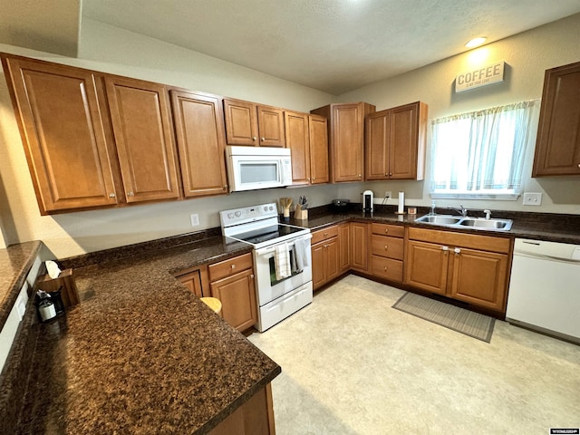 kitchen featuring white appliances and sink