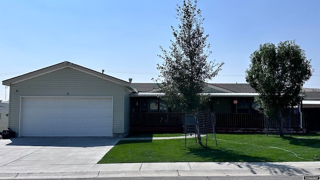 single story home with a garage, a front yard, and covered porch