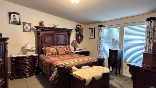 carpeted bedroom with lofted ceiling