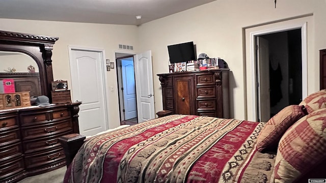 carpeted bedroom featuring vaulted ceiling