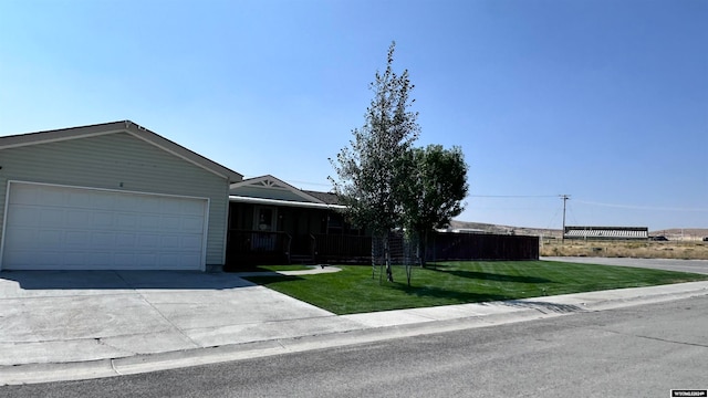 ranch-style home with a front yard and a garage