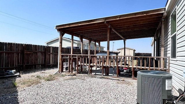 view of patio with a storage shed and central AC