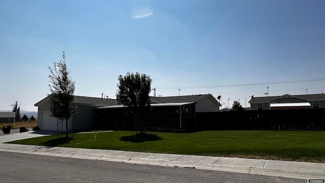 view of front facade with a front yard and a garage