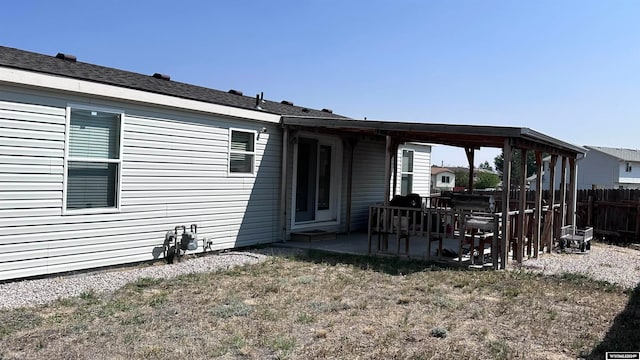 rear view of property with a yard and a patio