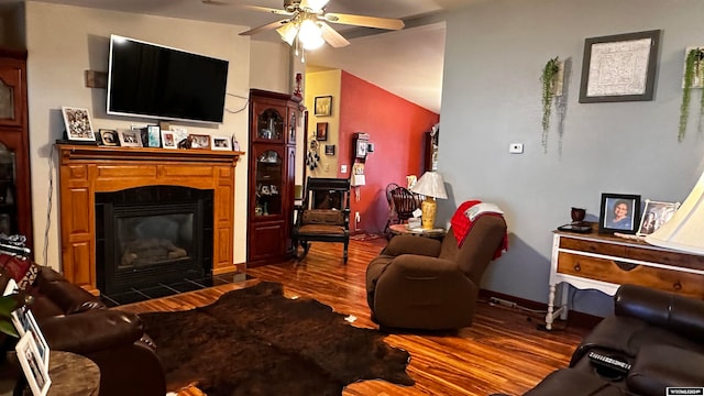 living room featuring ceiling fan, dark hardwood / wood-style flooring, and vaulted ceiling