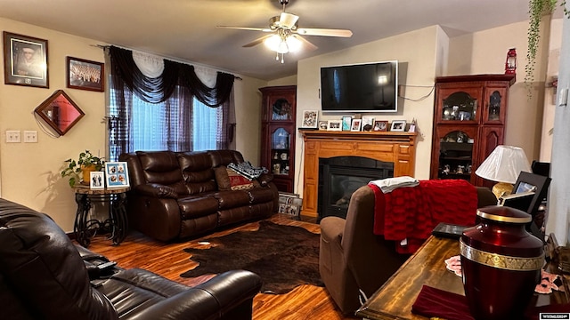 living room featuring lofted ceiling, wood-type flooring, and ceiling fan