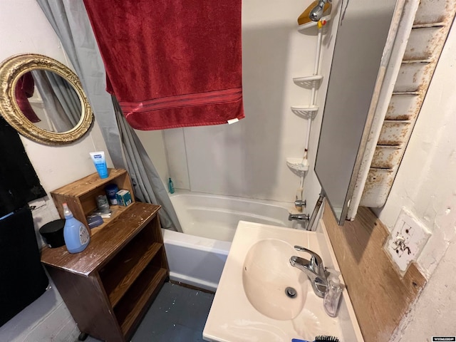 bathroom featuring shower / bath combination with curtain and sink