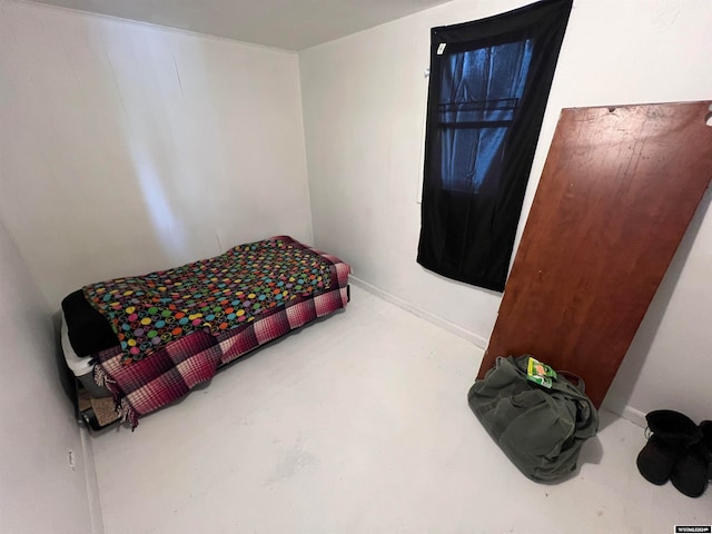 bedroom featuring concrete floors