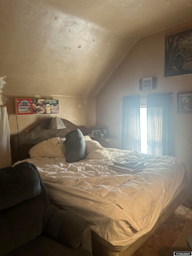 bedroom with lofted ceiling