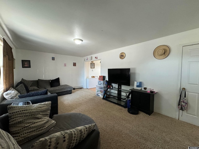 living room with a baseboard heating unit and carpet