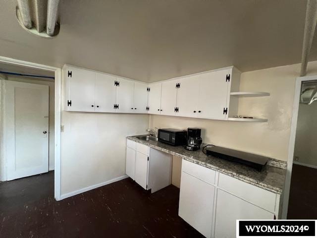kitchen featuring sink and white cabinetry