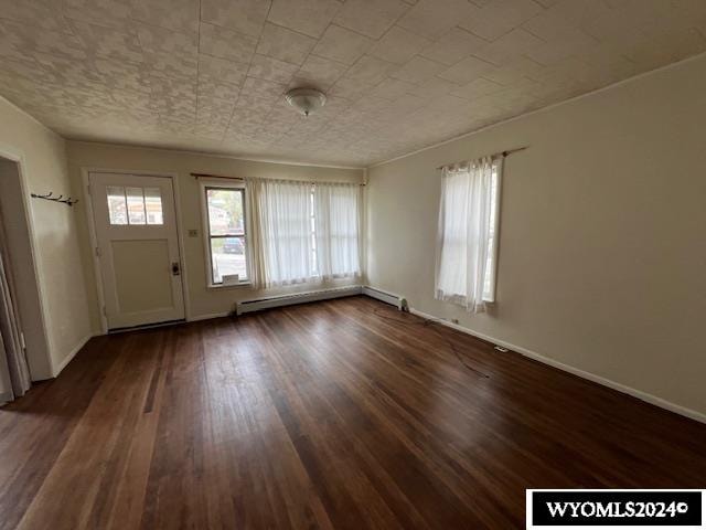 foyer entrance featuring baseboard heating and dark hardwood / wood-style floors