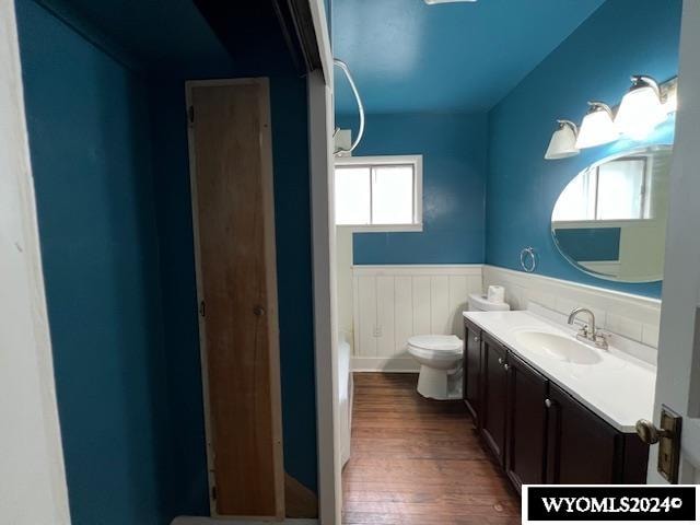 bathroom featuring vanity, toilet, and hardwood / wood-style floors
