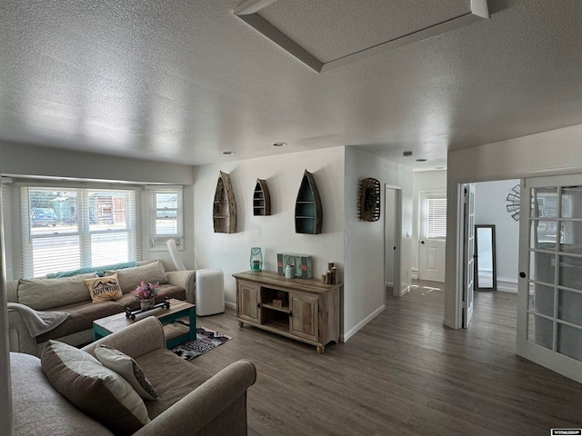 living room featuring dark hardwood / wood-style floors and a textured ceiling