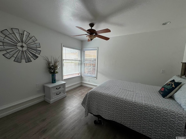 bedroom featuring a textured ceiling, ceiling fan, and wood-type flooring