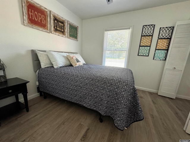 bedroom featuring hardwood / wood-style floors and a closet