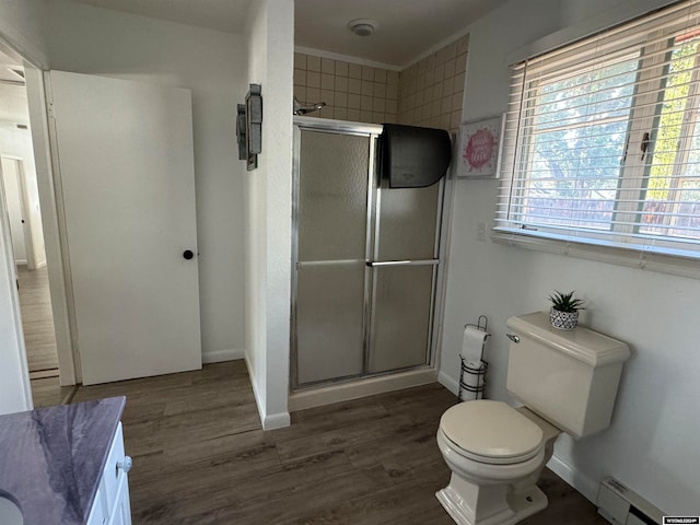 bathroom featuring a shower with shower door, toilet, and hardwood / wood-style flooring