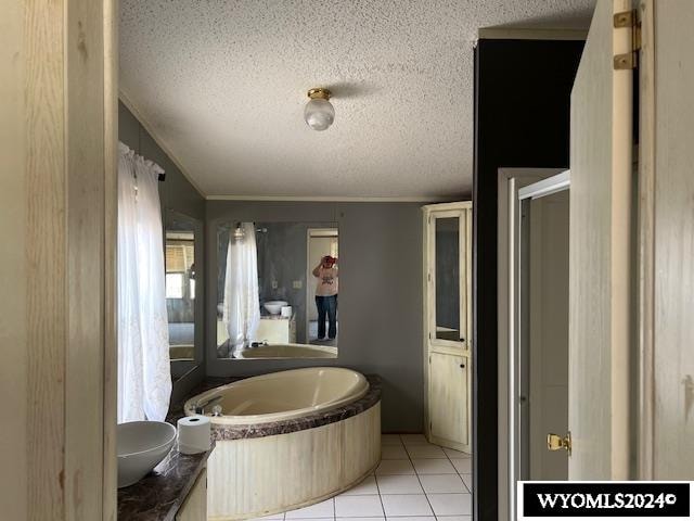 bathroom with tile patterned floors, independent shower and bath, vanity, and a textured ceiling