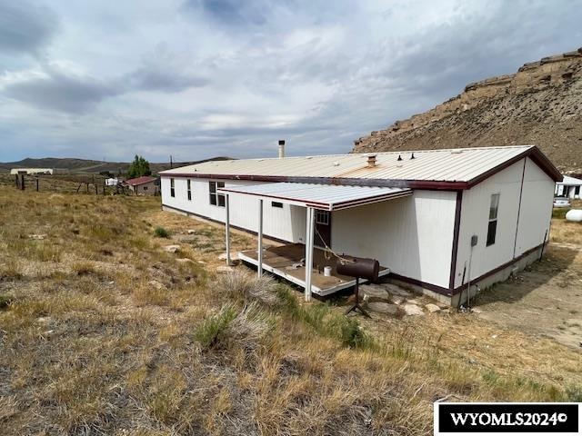 rear view of house featuring a rural view