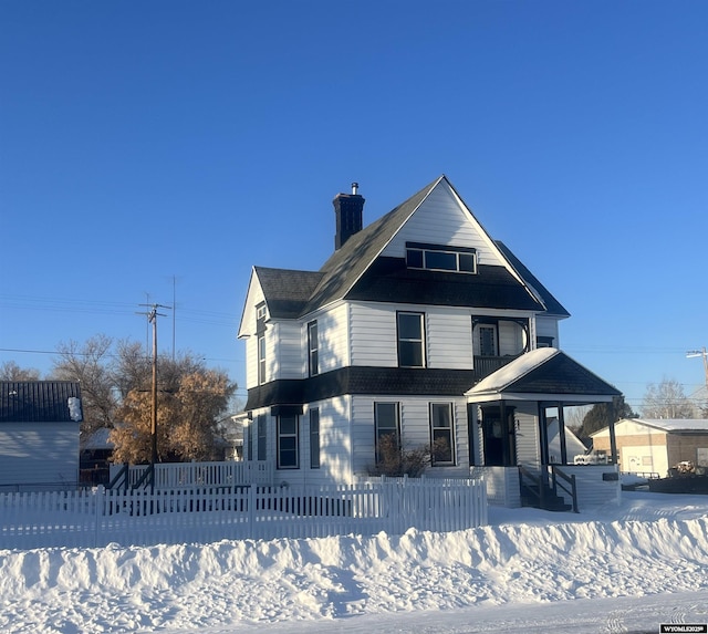 341 Main St, Evanston, WY 82930 - victorian-style house with a fenced front yard and a chimney