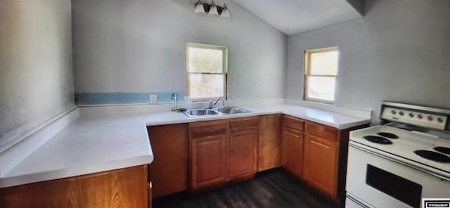 kitchen featuring white electric range, sink, and vaulted ceiling