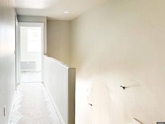 hallway featuring a textured ceiling