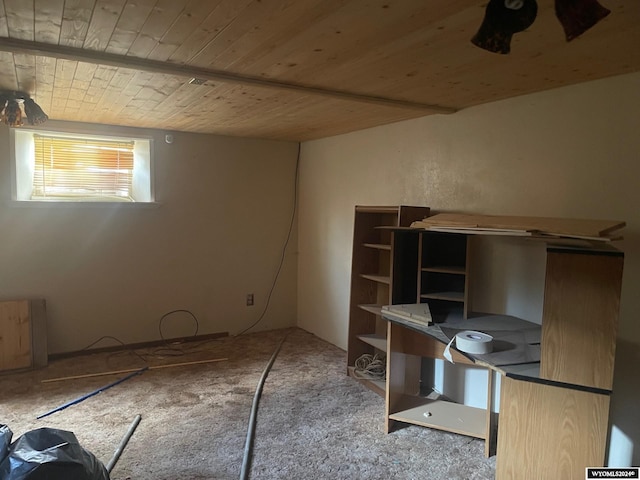 basement featuring wooden ceiling and carpet floors