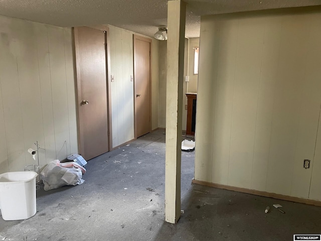 basement featuring a textured ceiling