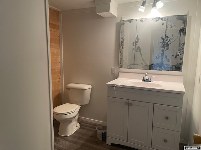 bathroom with vanity, toilet, and wood-type flooring