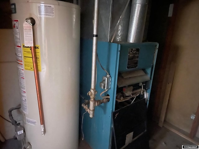 utility room featuring gas water heater and heating unit