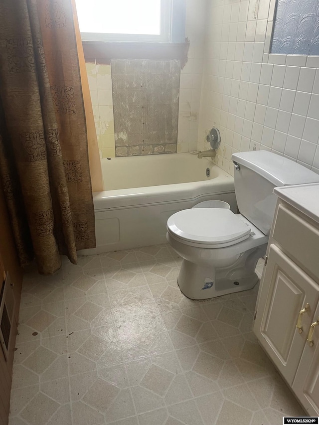 full bathroom featuring vanity, tile patterned flooring, tile walls, toilet, and shower / bath combo with shower curtain