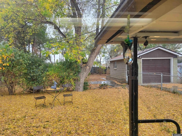 view of yard with an outdoor structure and a garage