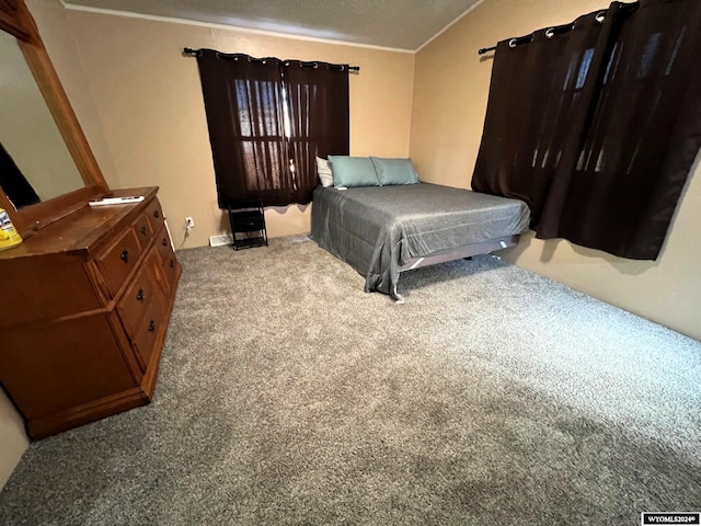 bedroom featuring lofted ceiling, ornamental molding, and carpet floors