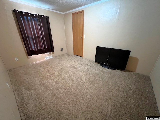 unfurnished room with light colored carpet, crown molding, and a textured ceiling