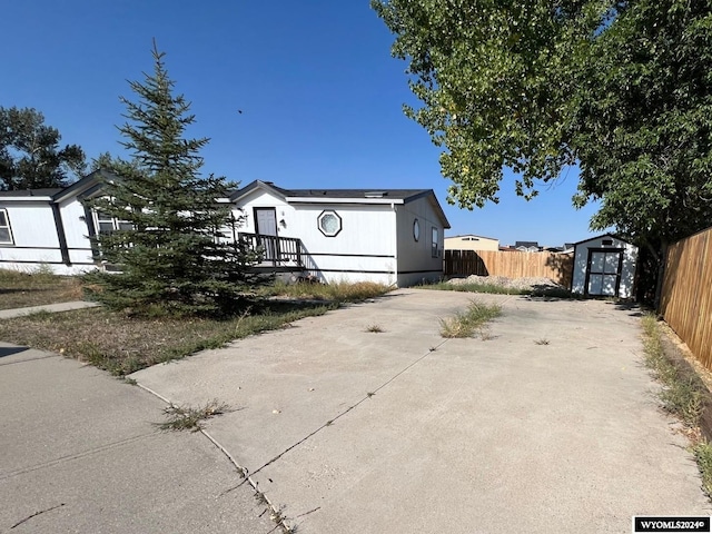 view of front of home featuring a shed