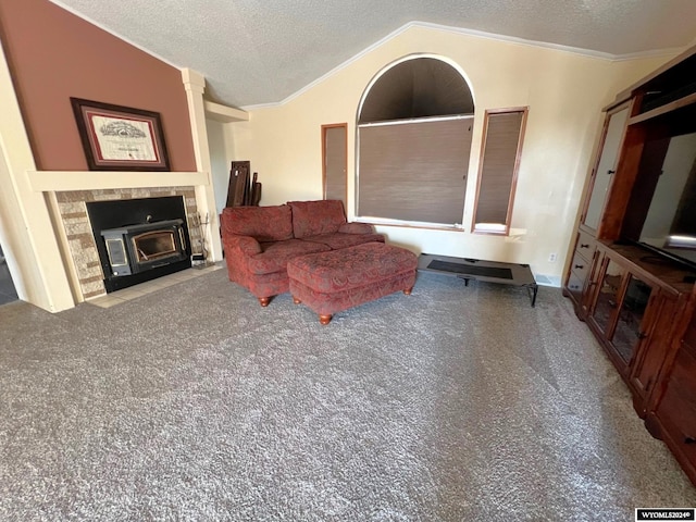 living room with a tiled fireplace, crown molding, a textured ceiling, carpet flooring, and lofted ceiling