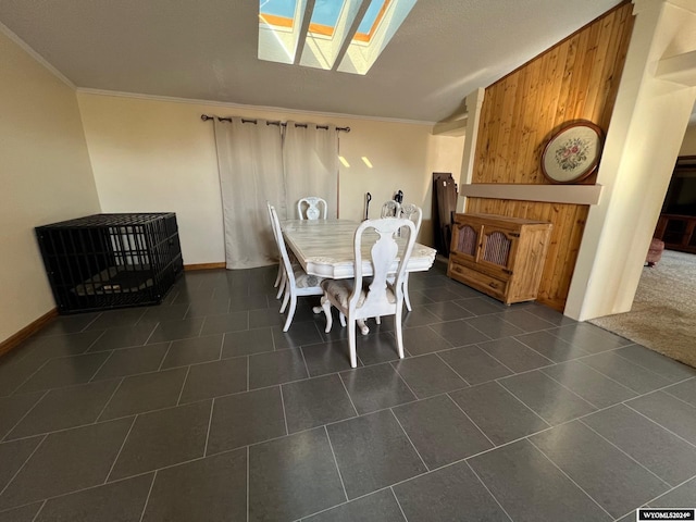 dining room featuring crown molding and dark tile patterned floors