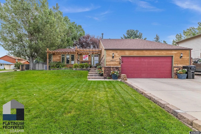 view of front of property featuring a front yard, a pergola, and a garage