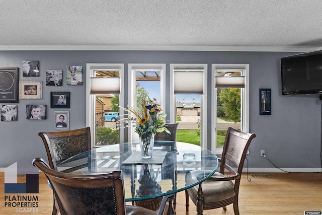 dining space with crown molding and a wealth of natural light