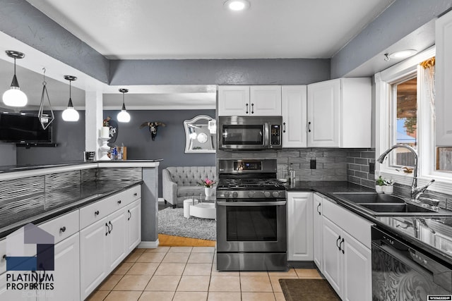 kitchen featuring white cabinets, light tile patterned floors, stainless steel appliances, and sink